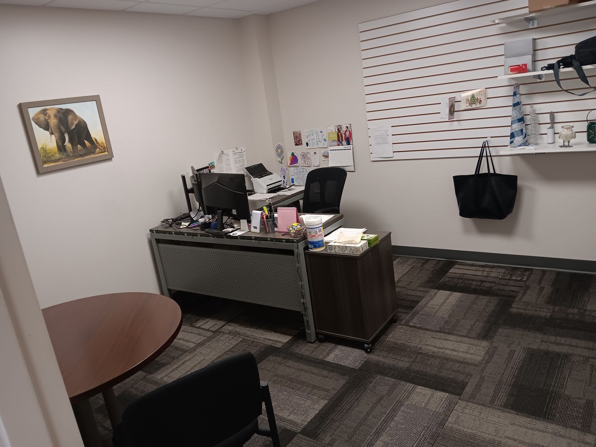 A room with a picture of a cat on the wall