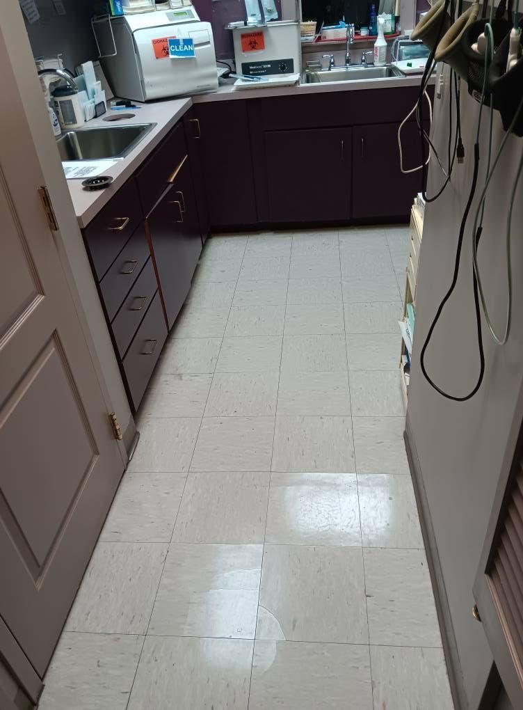 A kitchen with purple cabinets and white tile floors