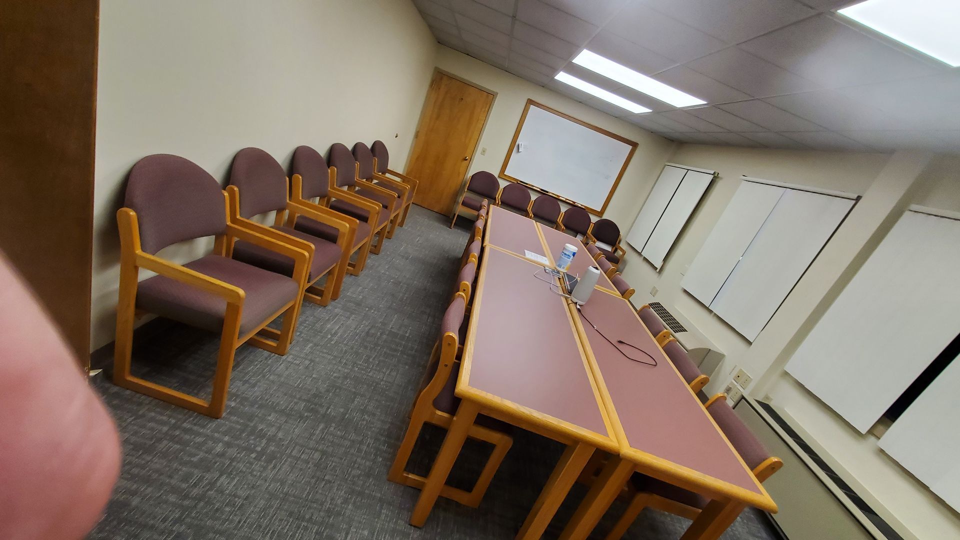 A conference room with a long table and chairs