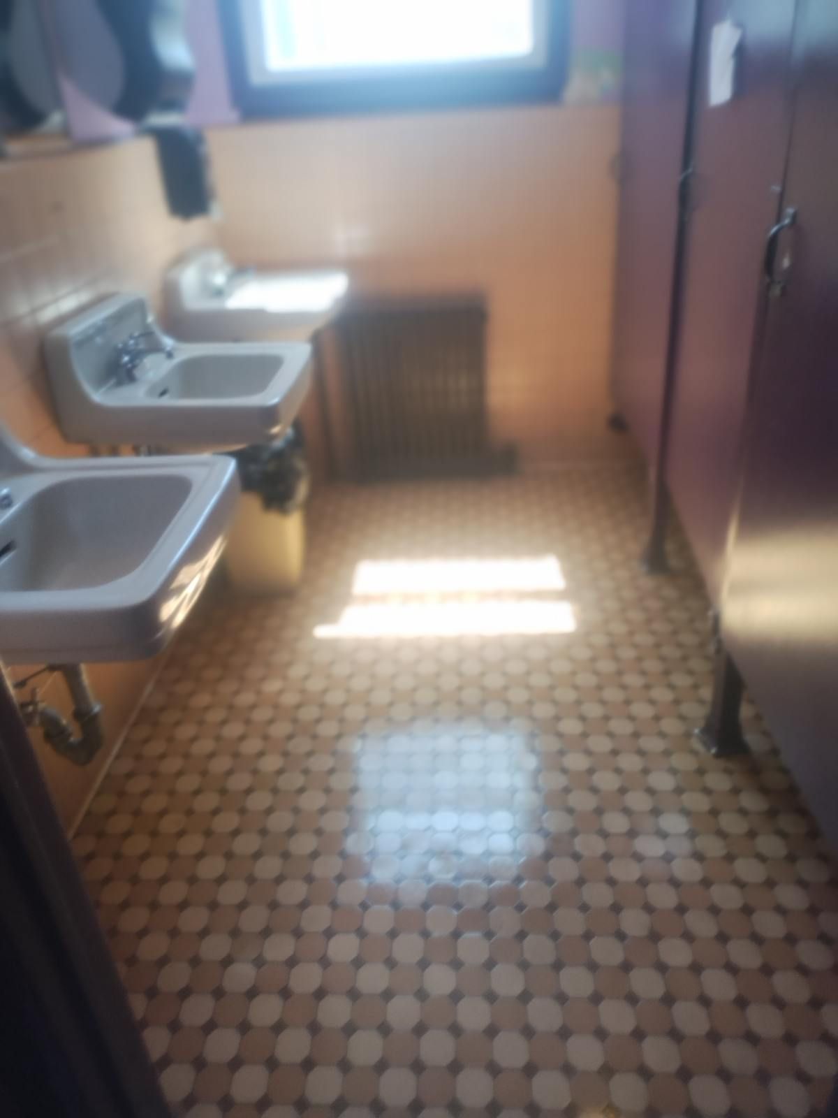 A bathroom with two sinks and a window