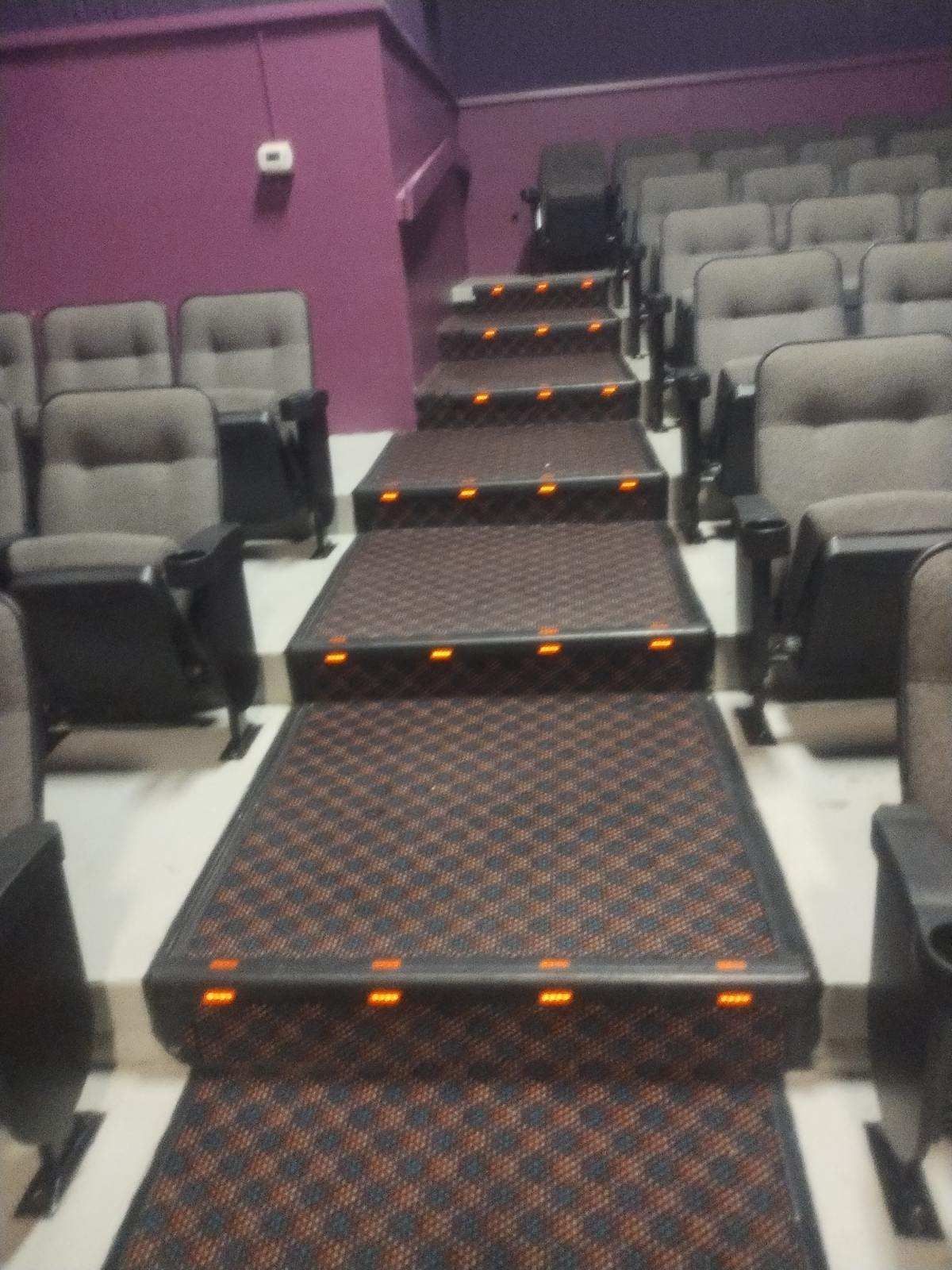 A row of seats in a theater with stairs leading up to them