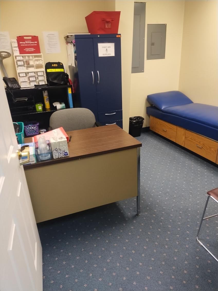 A room with a desk and a bed that says fox on it