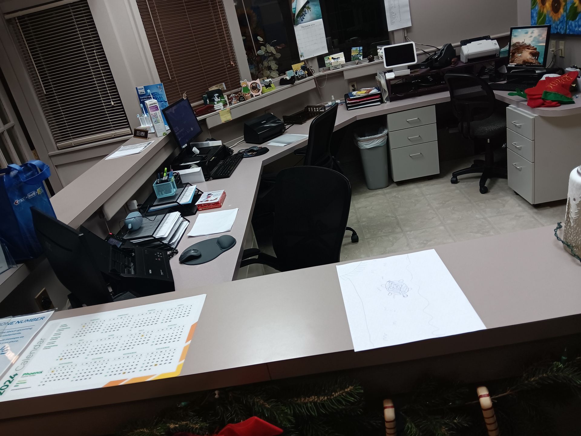 A desk in an office with a calendar on it