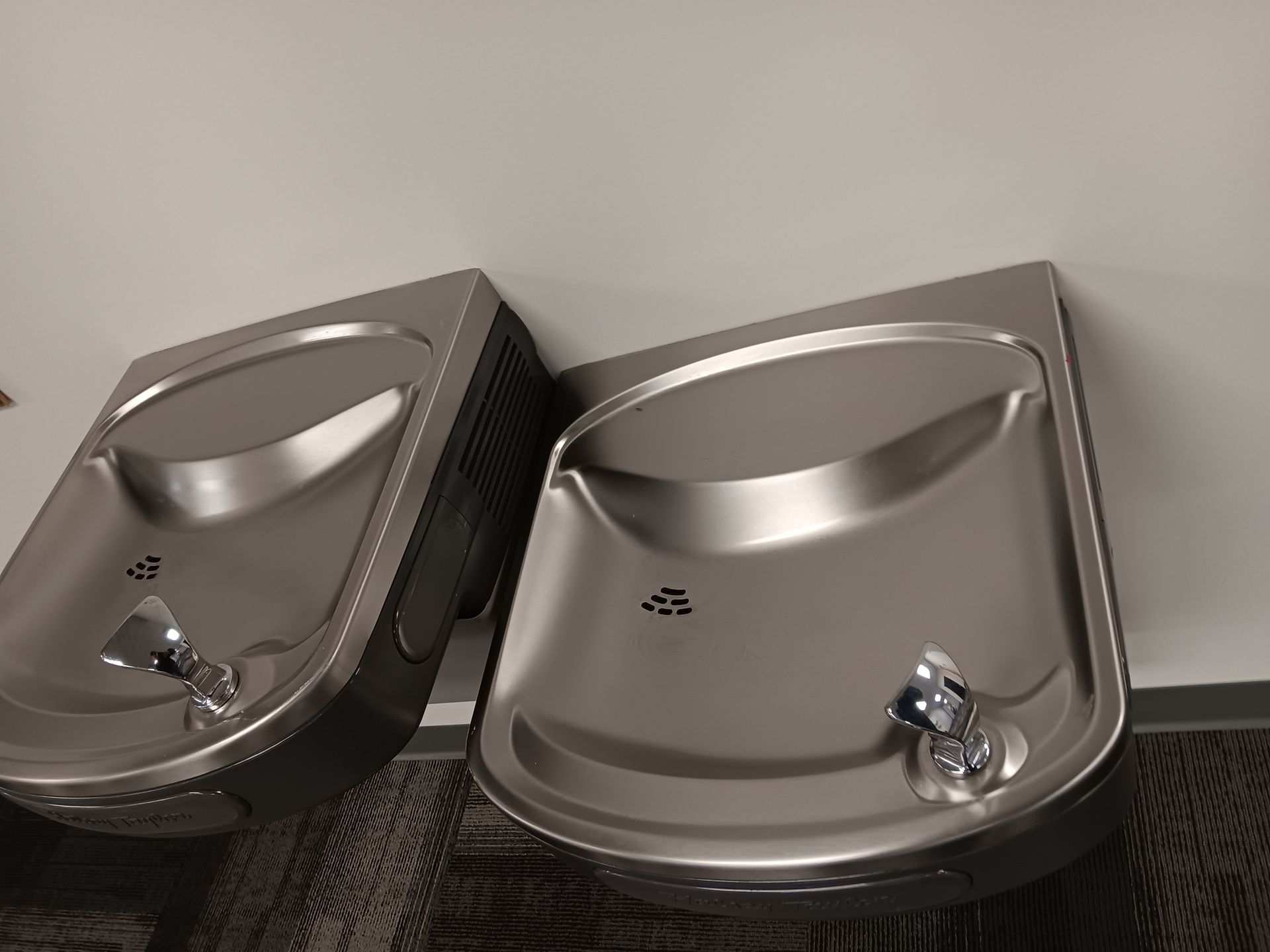 Two stainless steel sinks are sitting next to each other