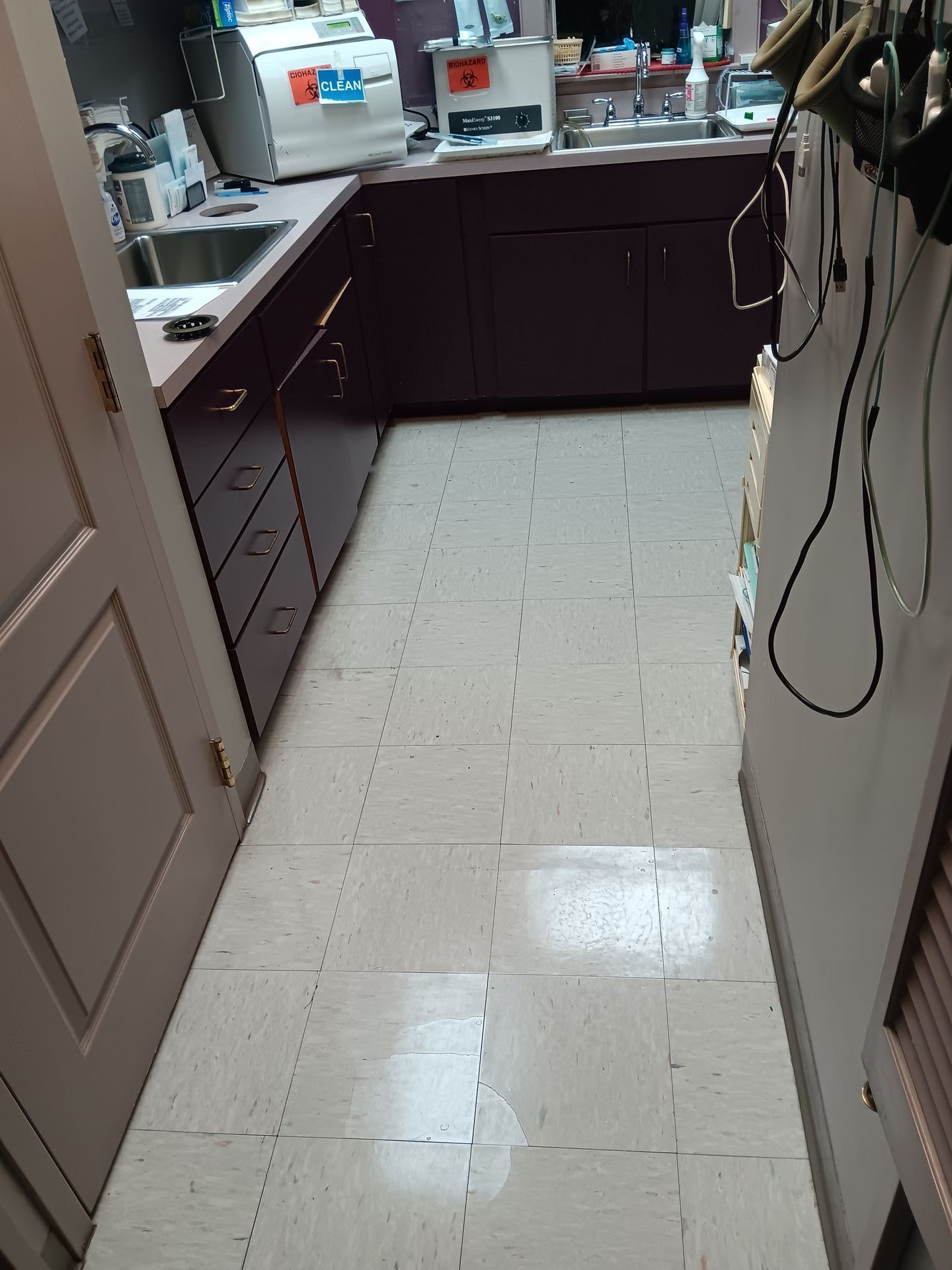 A kitchen with purple cabinets and white tile floors