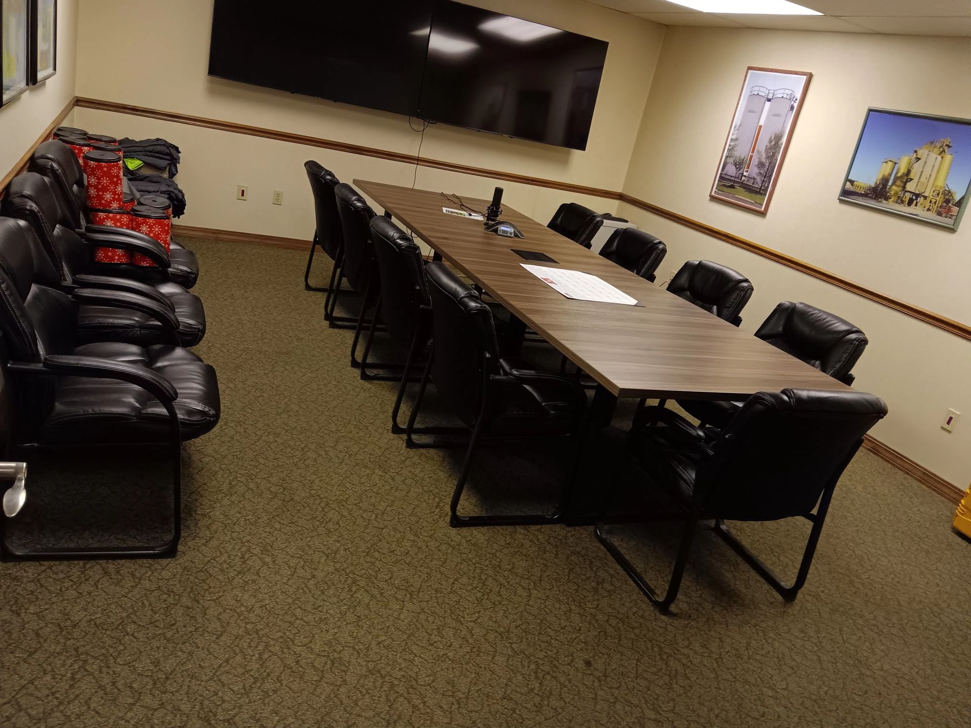A conference room with a long table and chairs