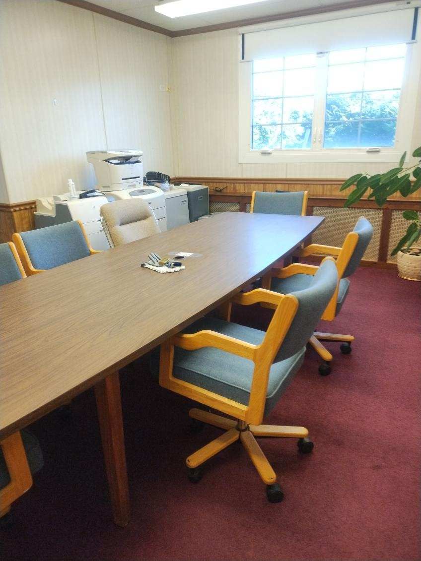 A conference room with a long table and chairs