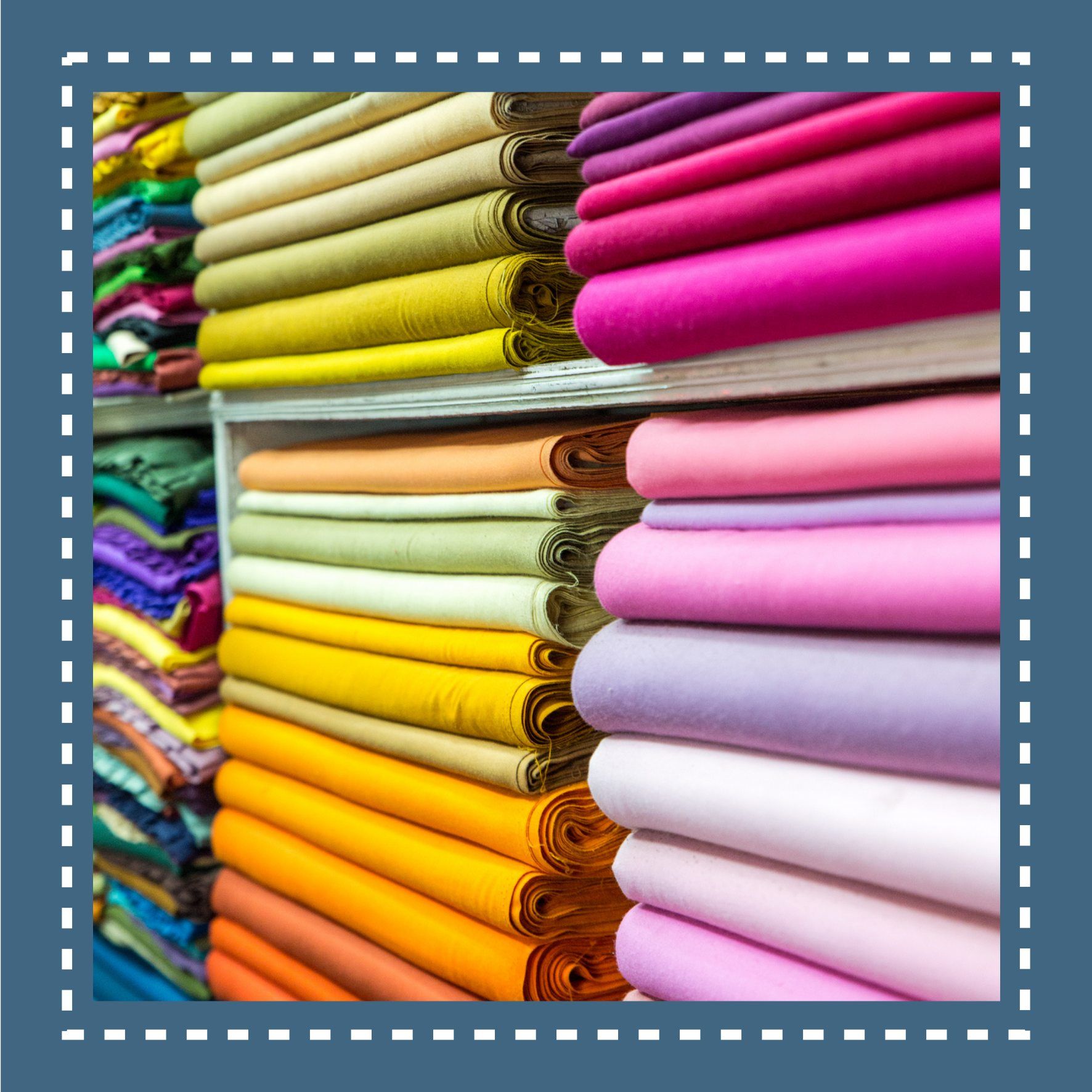 Shelves of folded colorful fabric rolls in a store.