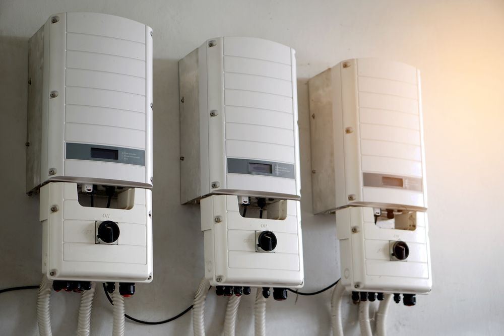 Three Solar Panel Inverters Are Hanging on a Wall — Burnett Home Energy Centre in Bundaberg Central, QLD