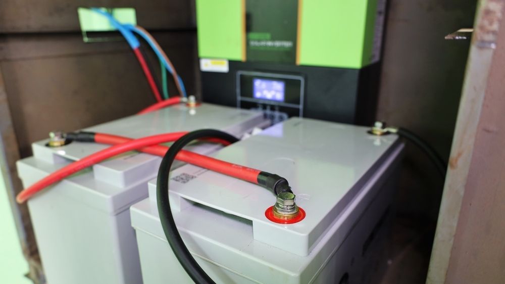 Two Batteries Are Connected to a Charger in a Room — Burnett Home Energy Centre in Bundaberg Central, QLD