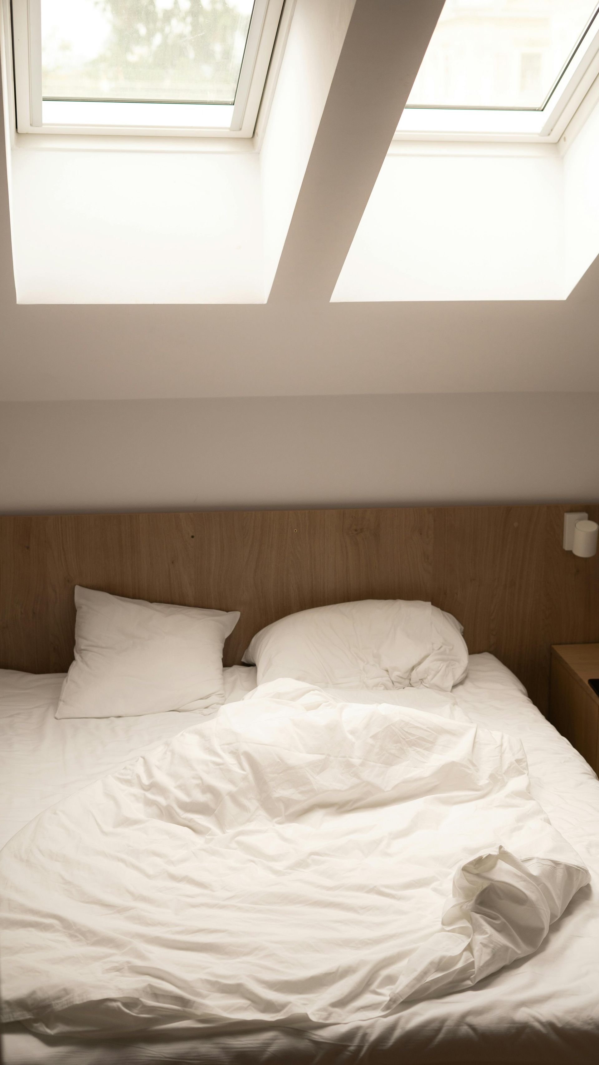 A Bed With White Sheets and Pillows in a Bedroom With a Skylight — Burnett Home Energy Centre in Bundaberg Central, QLD