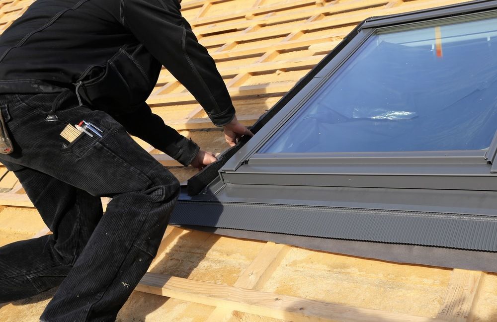 A Man is Installing a Skylight on a Roof — Burnett Home Energy Centre in Bundaberg Central, QLD