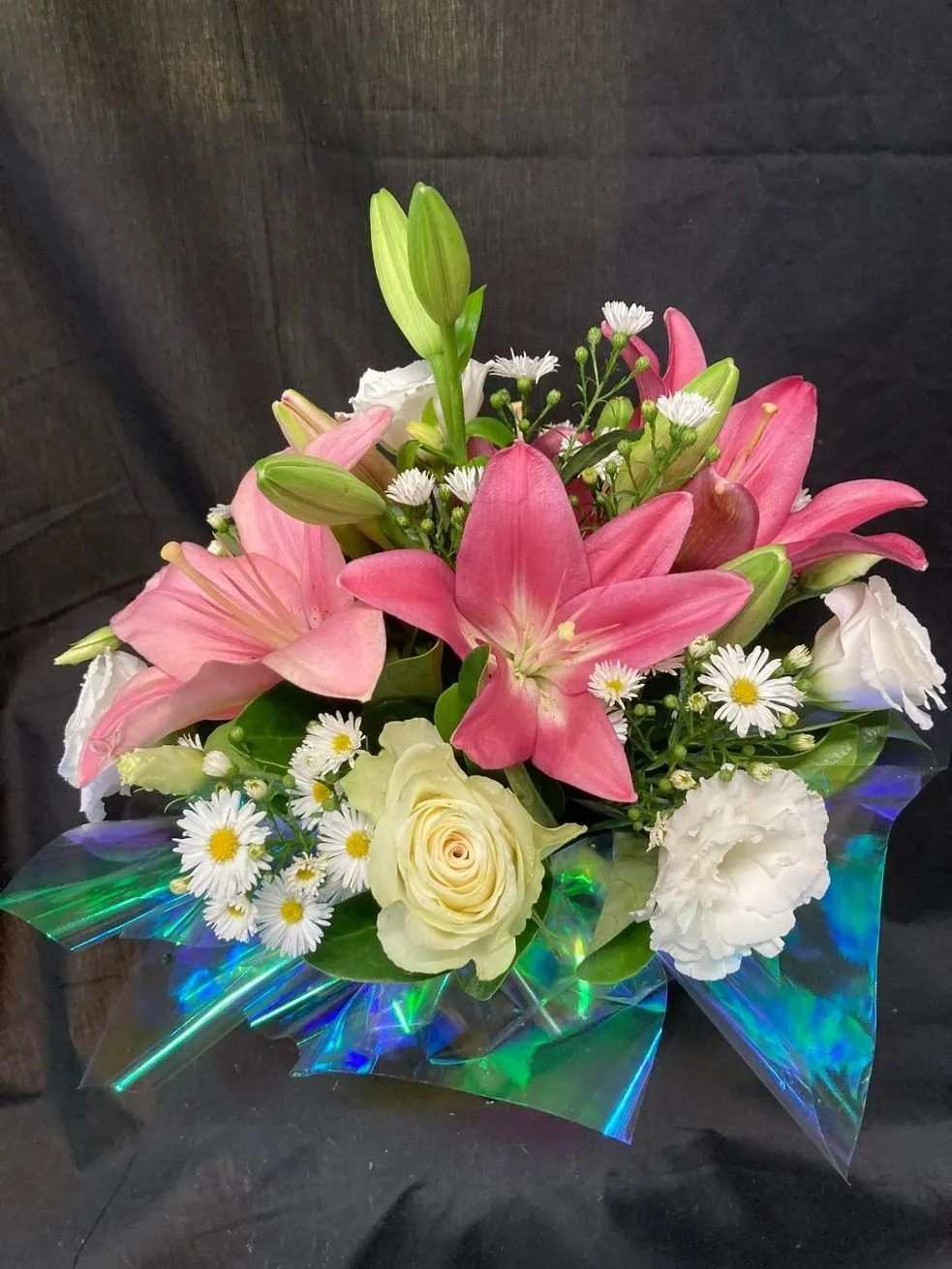 A Bouquet of Pink and White Flowers Wrapped in a Blue Ribbon — Wingham Nursery and Florist PTY Ltd In Wingham, NSW