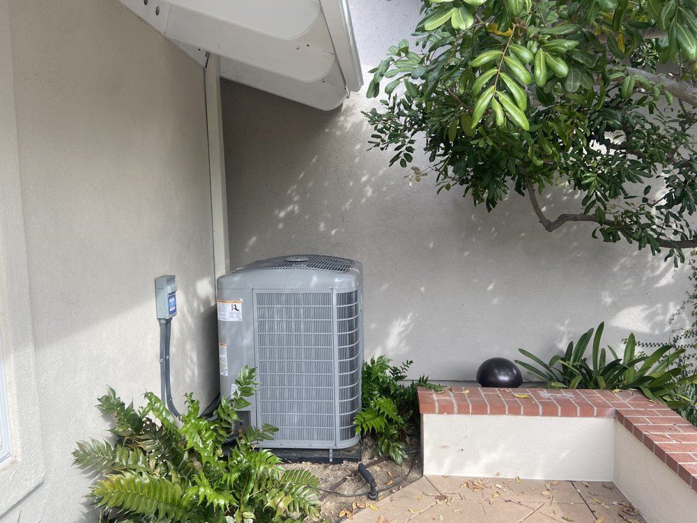 An air conditioner is sitting on the side of a building.