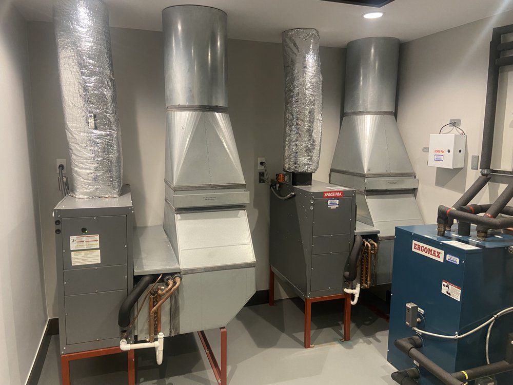 A room with a lot of pipes coming out of the ceiling.