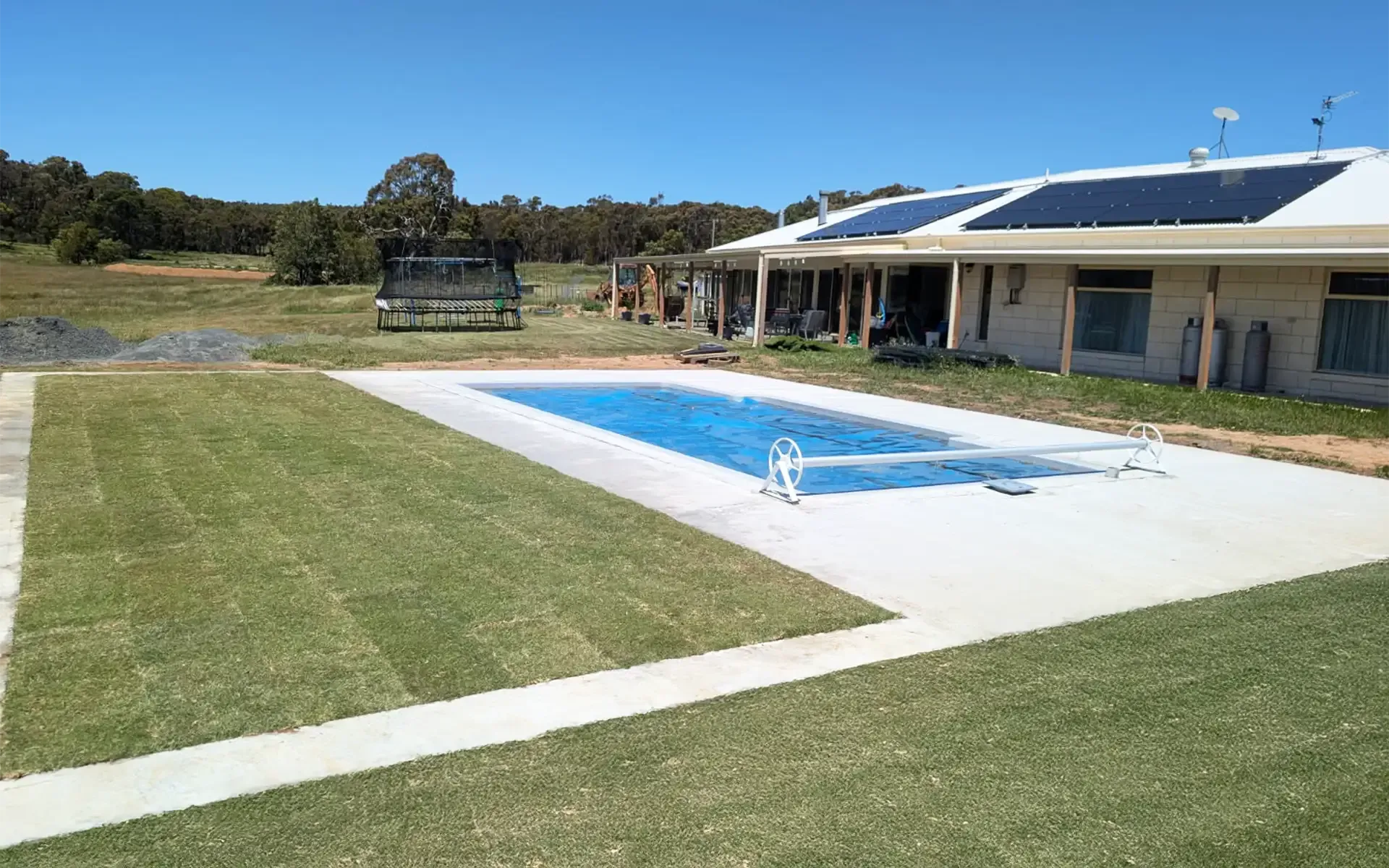 Landscaping project in Newtown for a pool with concrete, turf and paving installed. 