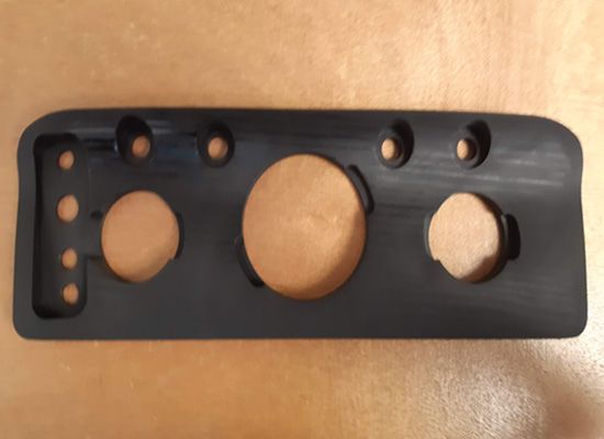 A black item with holes in it is on a table