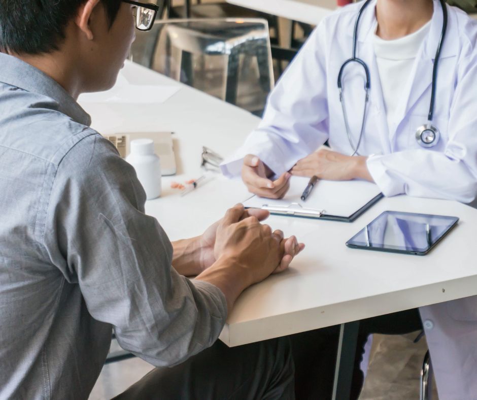 Patient consulting with a doctor at a desk