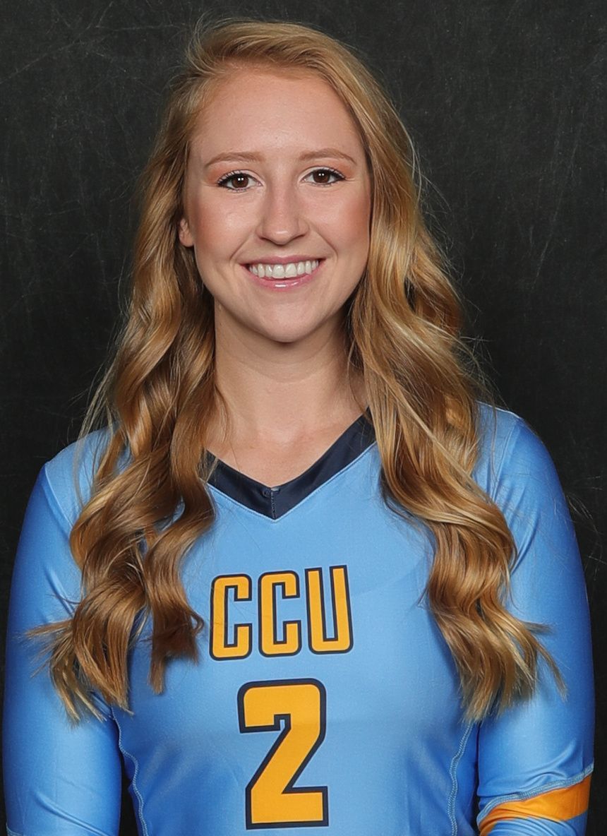 Blonde woman in blue jersey with