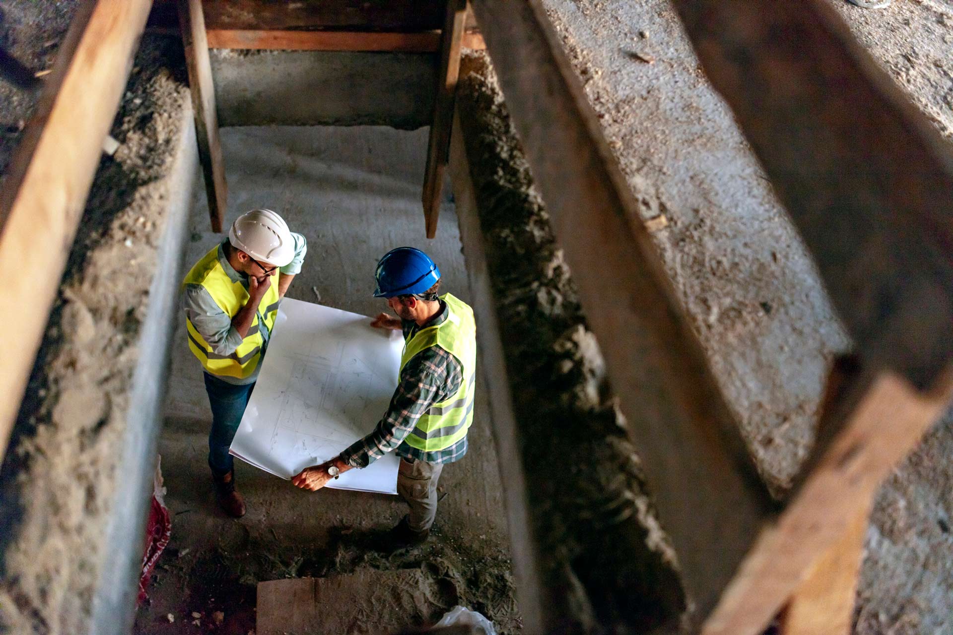 Architect and foreman analyzing the building plan