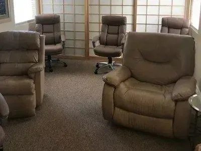 A living room filled with furniture and a sliding glass door.