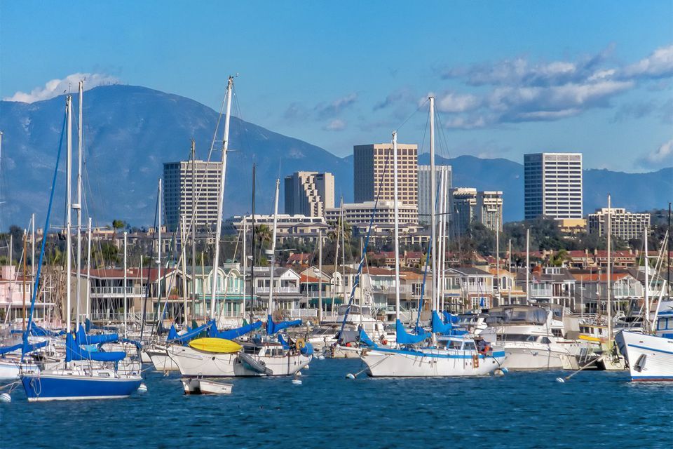 Newport Beach harbor with local mountains,  residences near the Fashion Island businesses.