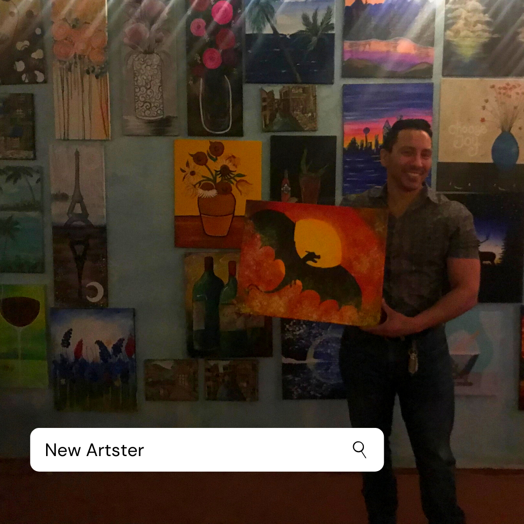 A man is holding a painting in front of a wall that says new artster