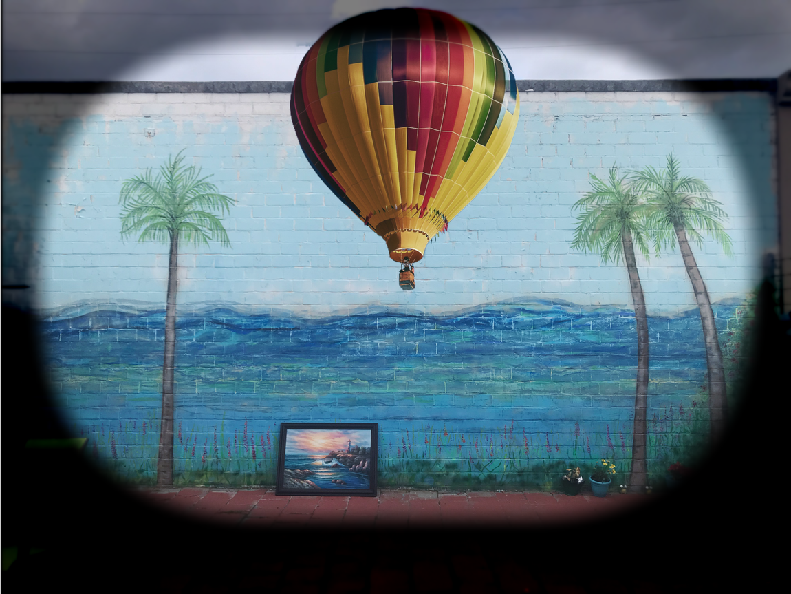 A painting of a hot air balloon on a wall