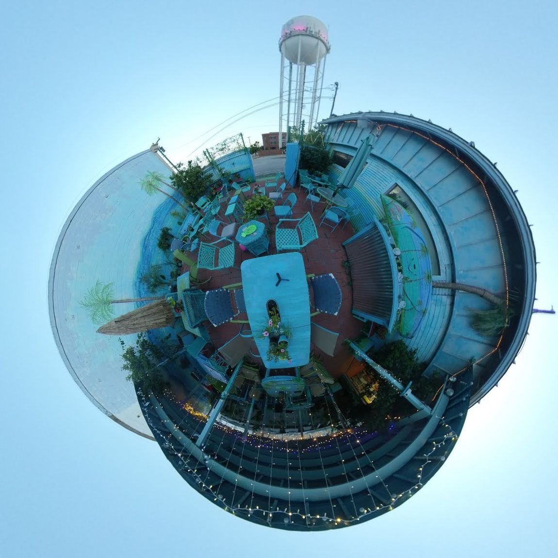 A small planet with a water tower in the middle