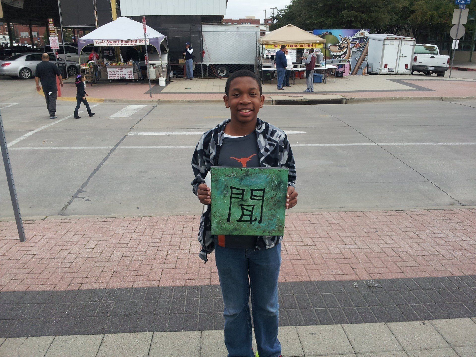 A young boy is holding a sign that says ' ee ' on it