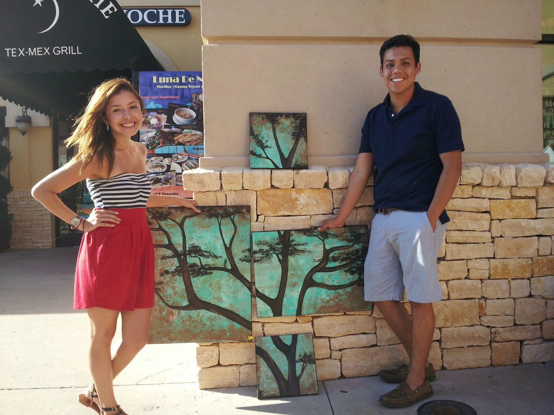 A man and a woman standing in front of a sign that says the oche