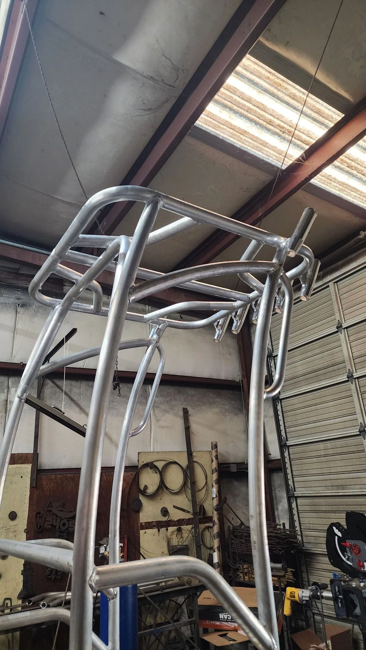 A newly constructed, aluminum boat T-top framework, in a workshop.