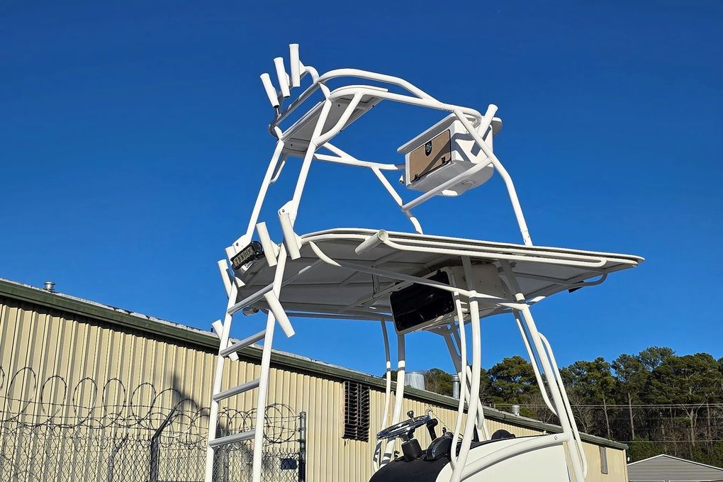 White boat tower with a canopy against a clear blue sky, likely for fishing.