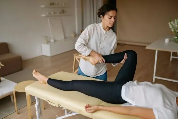 Professional assisted leg stretching for improved flexibility.