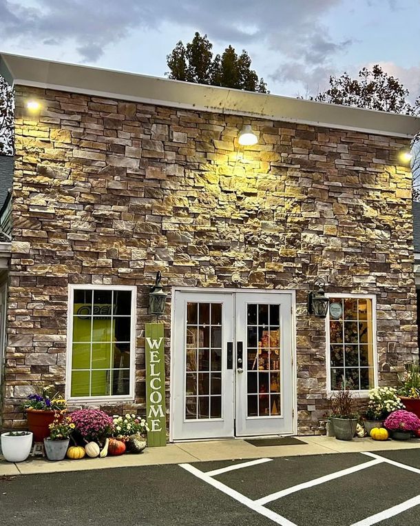 A brick building with a welcome sign in front of it