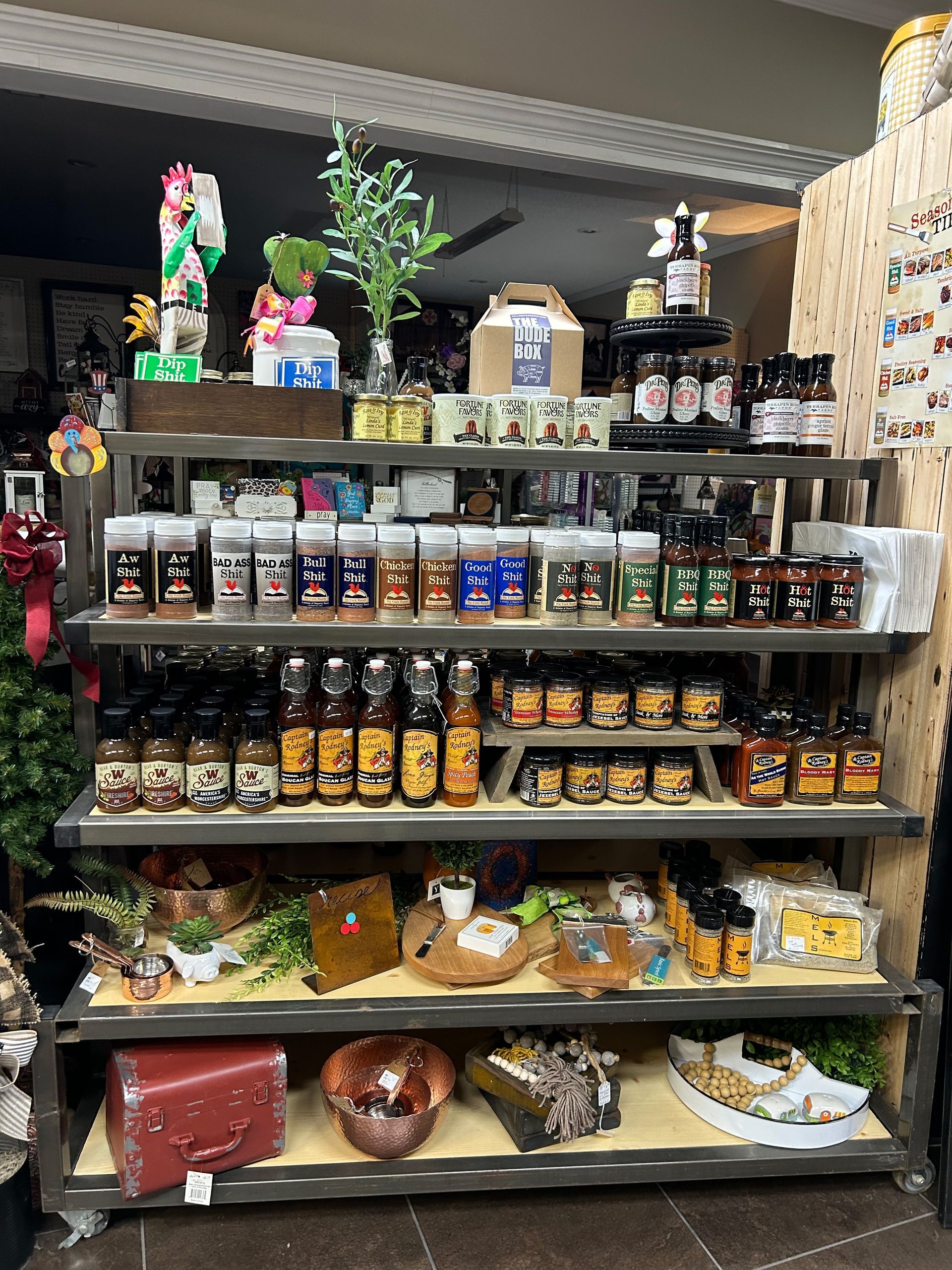A store shelf filled with lots of bottles and jars of food.