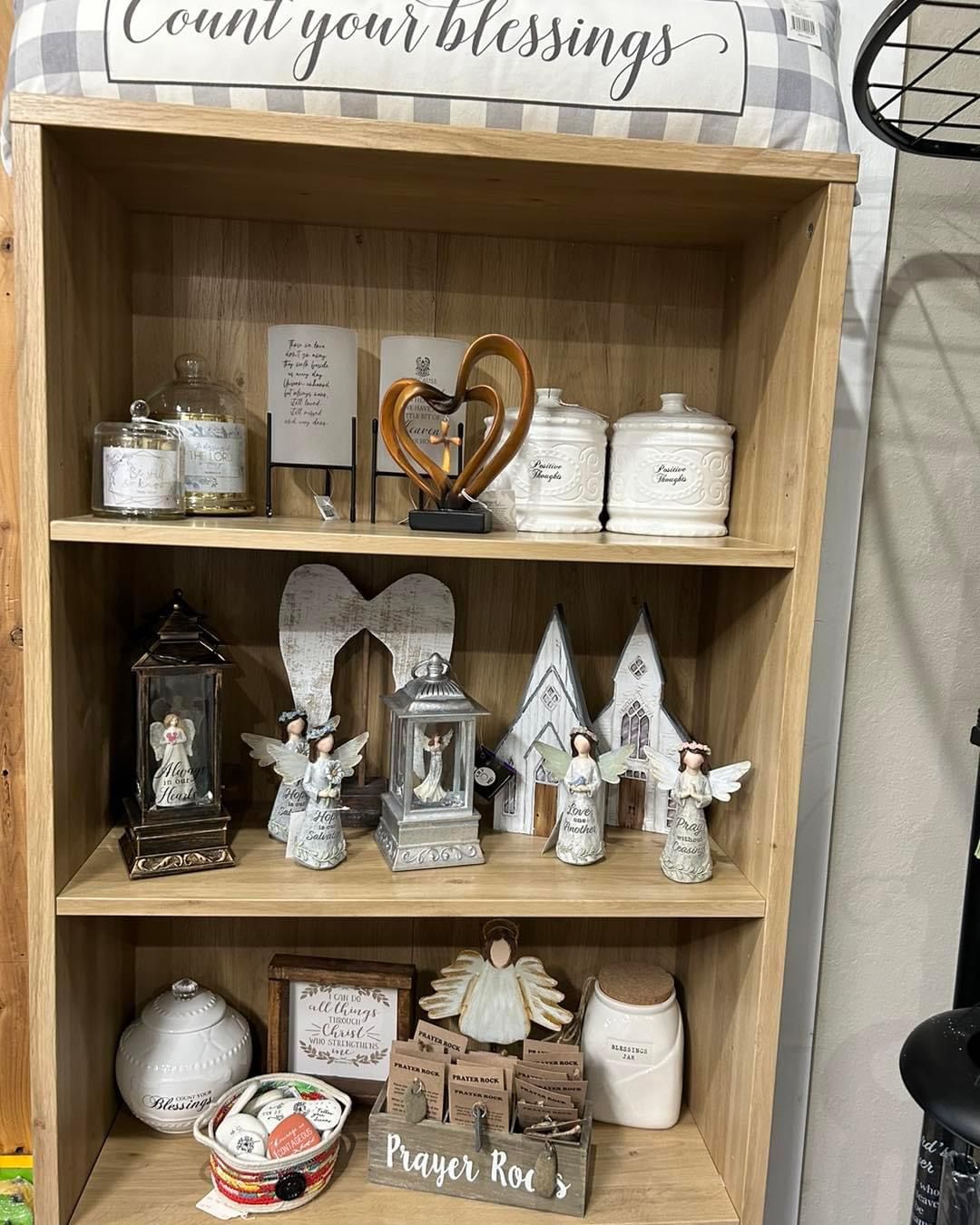 A wooden shelf filled with lots of decorations and candles.