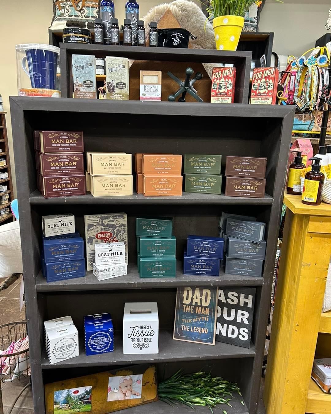 A shelf filled with lots of soaps and candles in a store.