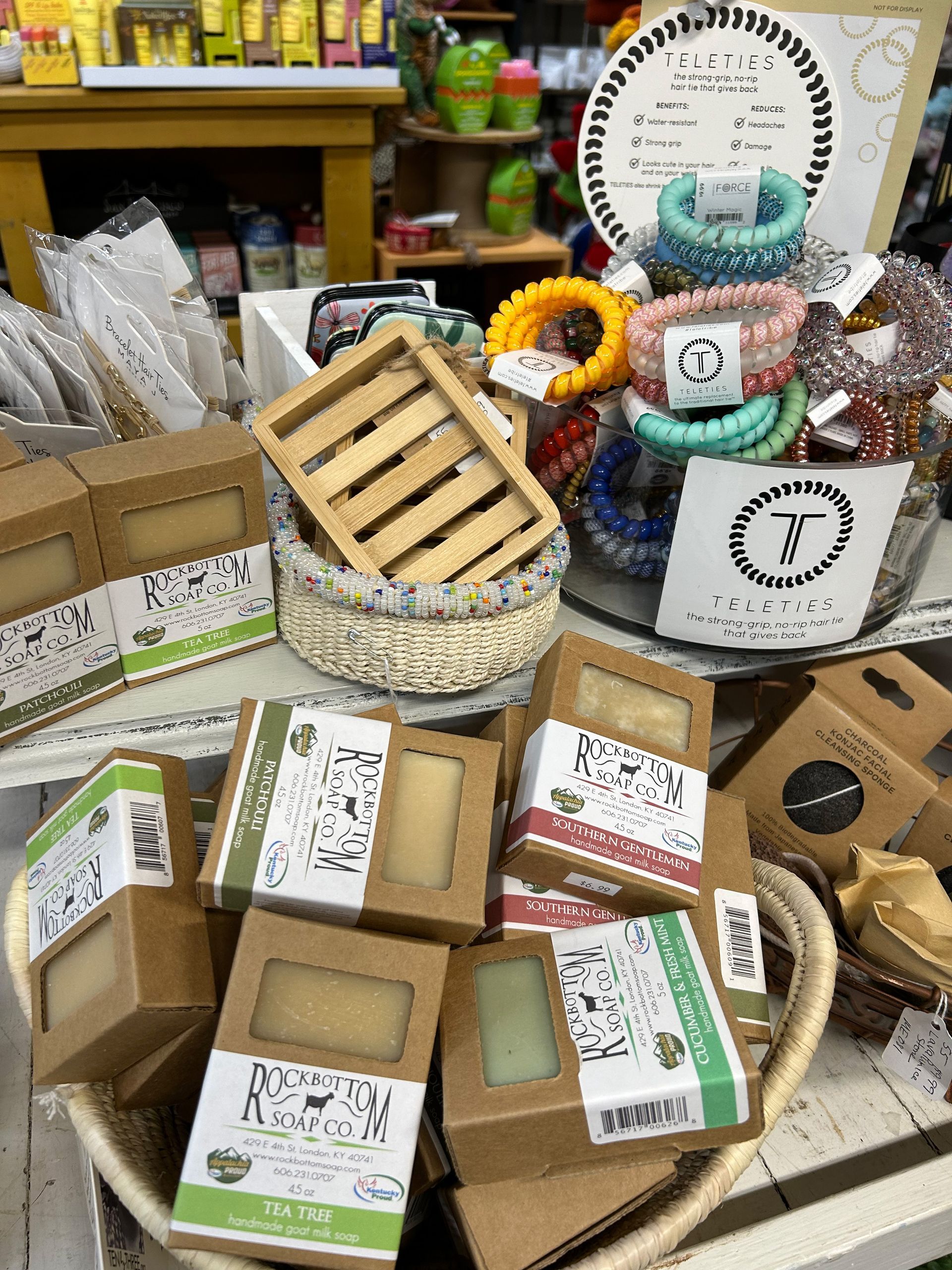 A bunch of soaps are sitting on a table in a store.