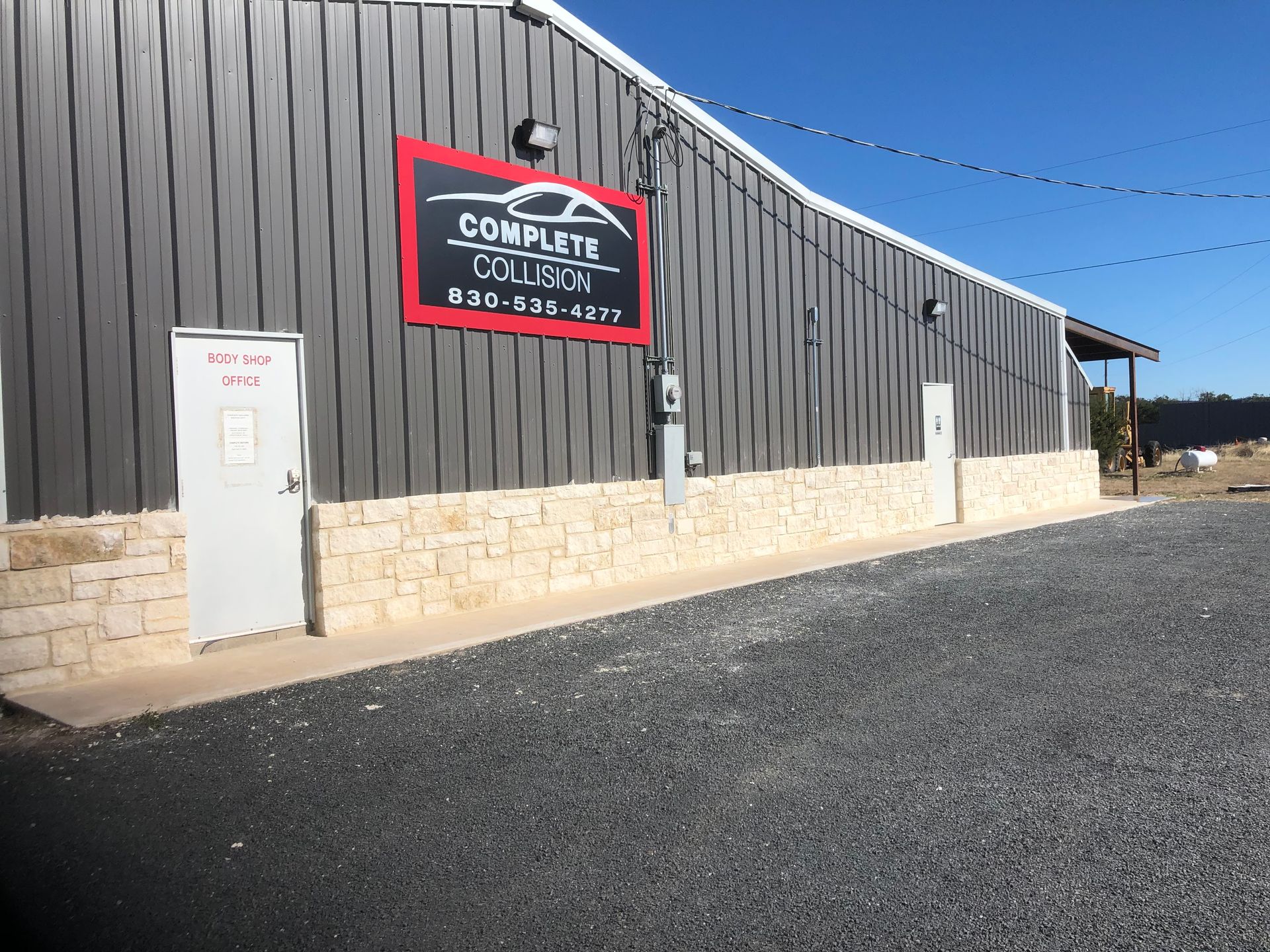 A building with a sign on the side that says complete collision