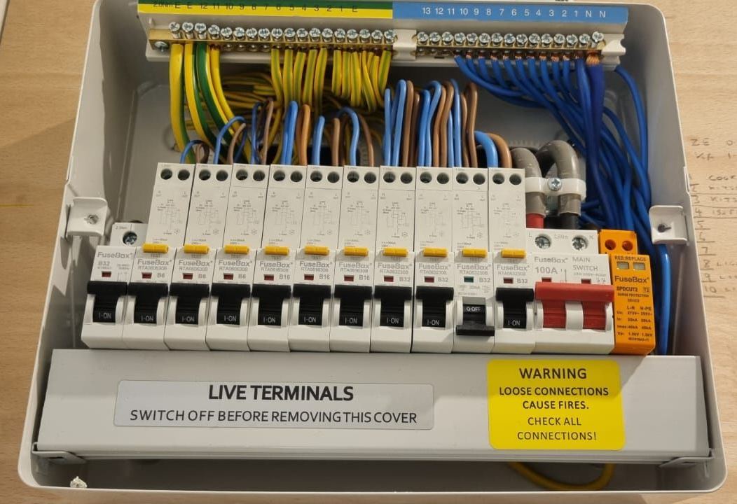 Electrician replacing consumer unit fuse board