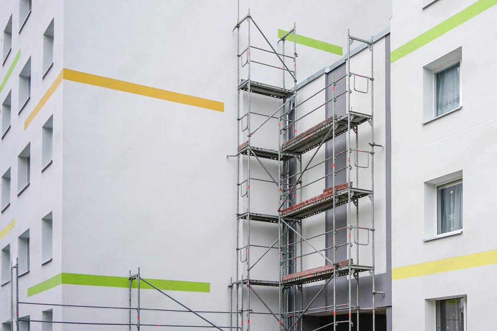 a white building with scaffolding on the side of it .