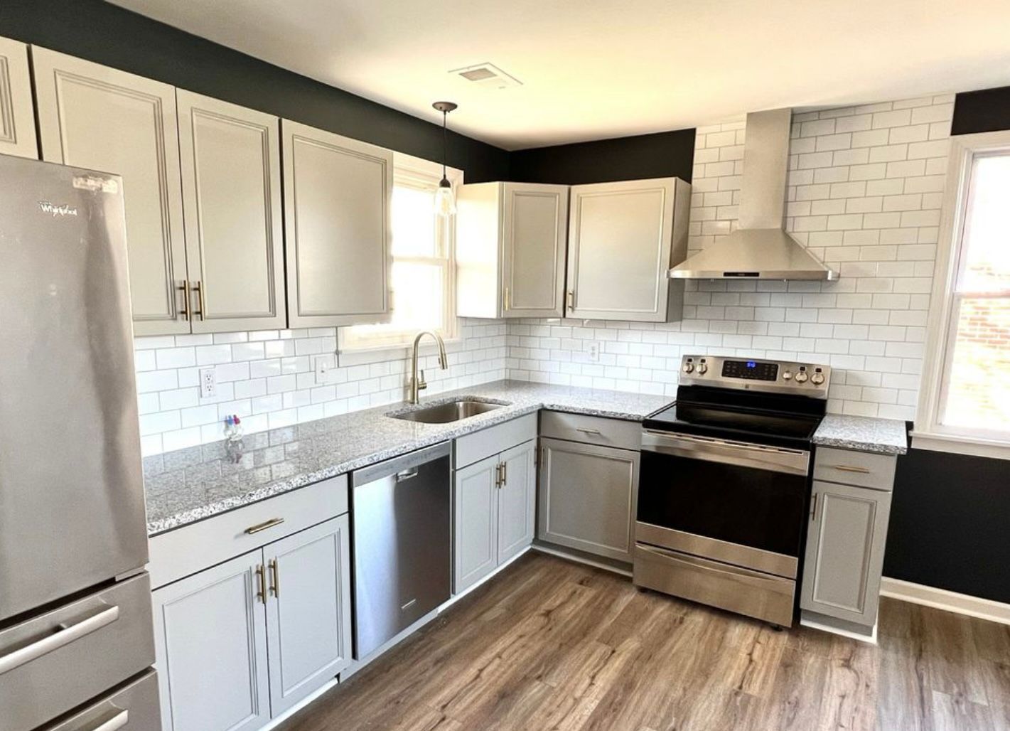 A kitchen with white cabinets and stainless steel appliances.