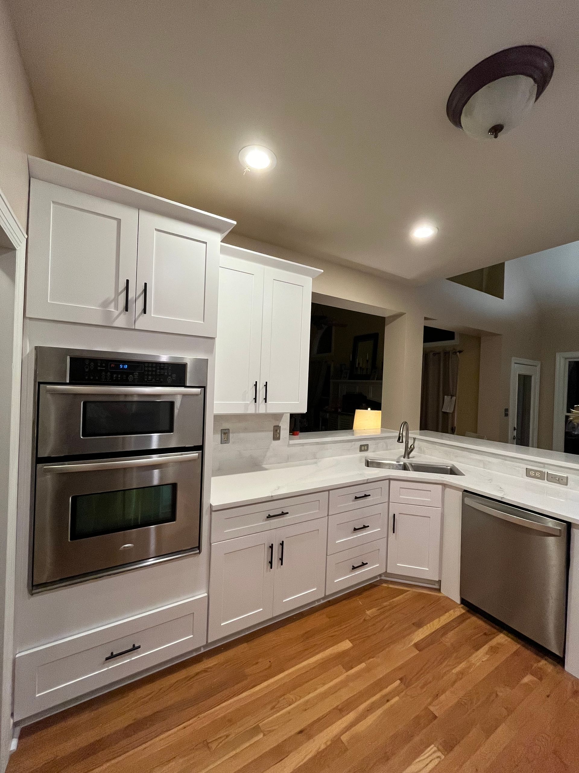 A kitchen with white cabinets and stainless steel appliances