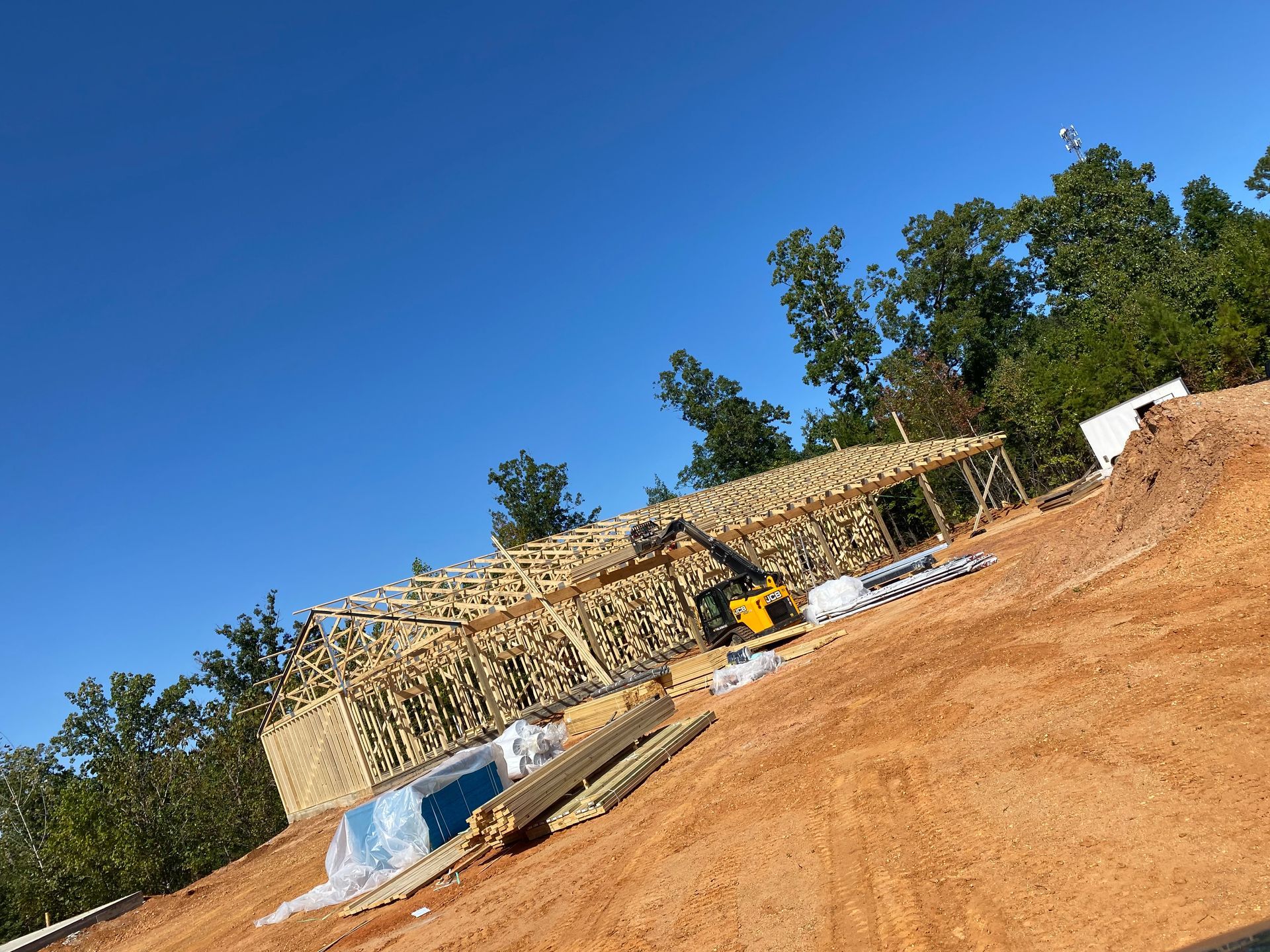 A house is being built on top of a dirt hill.