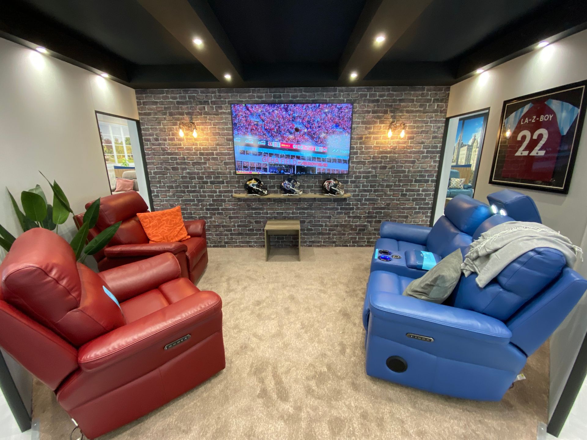burnt sienna and azure blue La-Z-Boy cinema chairs in cinema room with large screen telvision on display at the January Furniture Show 2024, NEC, Birmingham