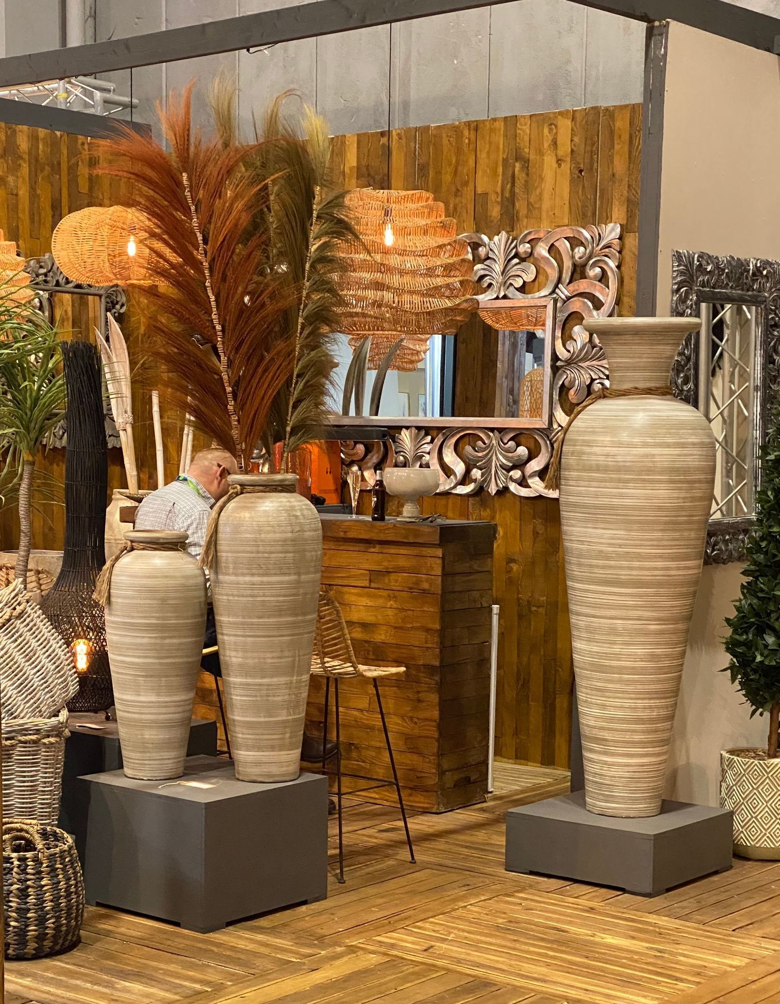a display of vases and lamps with a wooden wall background at the January Furniture Show 2024, NEC, Birmingham