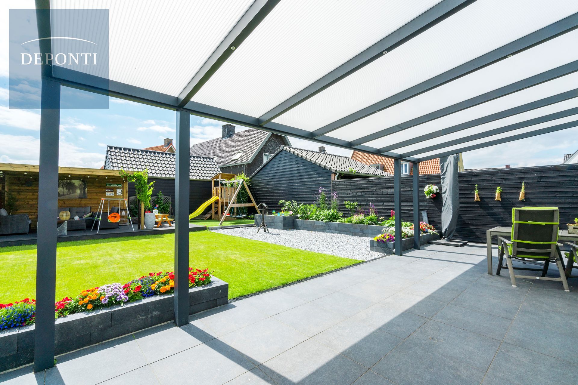 a patio with a clear roof and a playground in the background