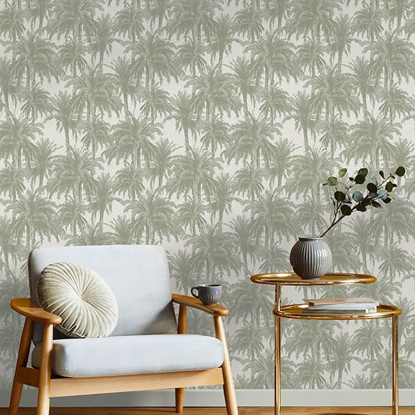 a living room with a chair and a table with palm trees on the wall