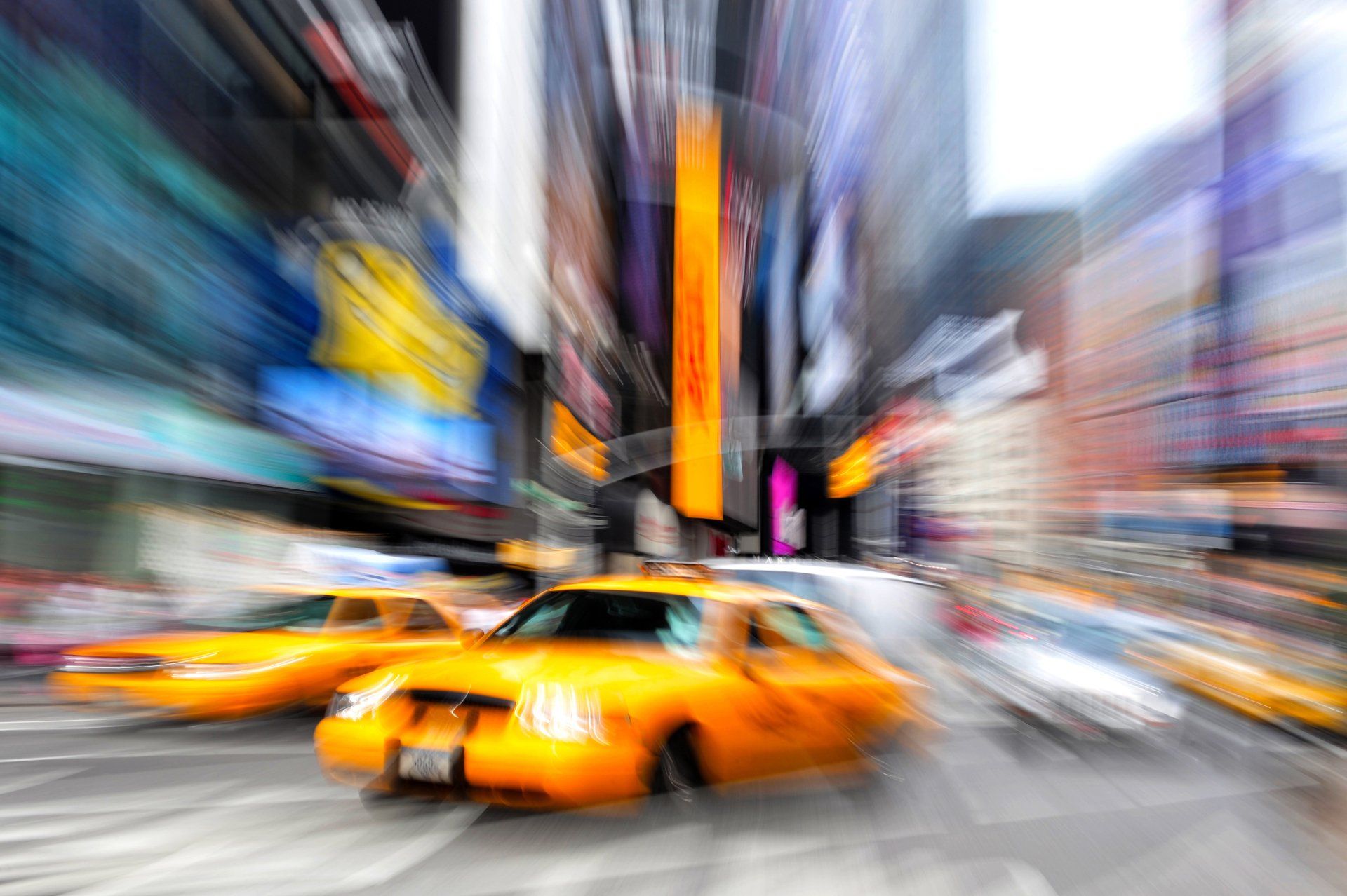 a blurry picture of taxis driving down a city street